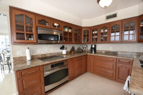 a kitchen with stainless steel appliances granite countertop a stove sink and cabinets