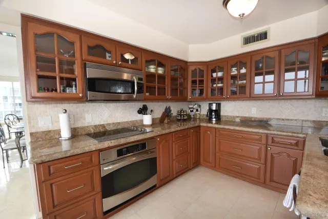 a kitchen with stainless steel appliances granite countertop a stove sink and cabinets
