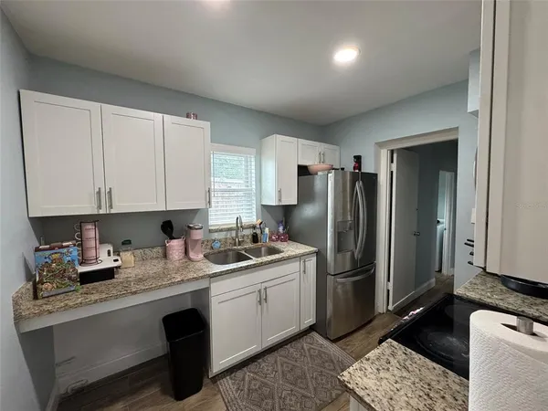 a kitchen with a sink cabinets and stainless steel appliances