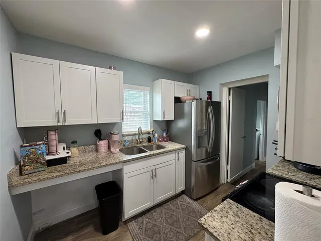 a kitchen with a sink cabinets and stainless steel appliances