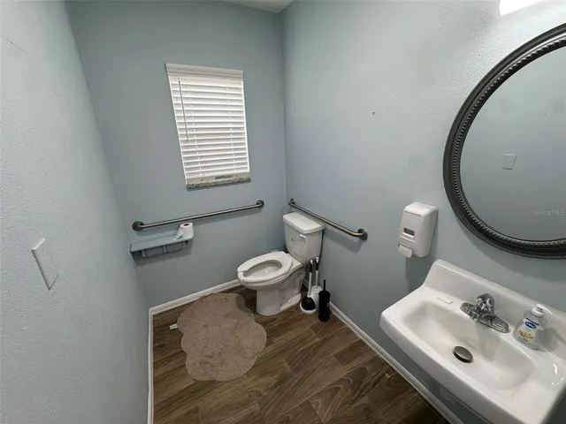 a bathroom with a sink toilet and mirror