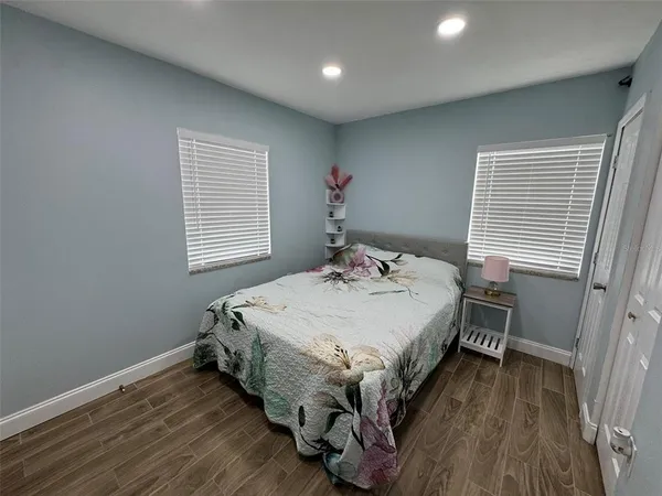 a bed sitting in a bedroom next to a window