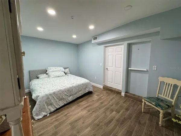 a bedroom with a bed and chair