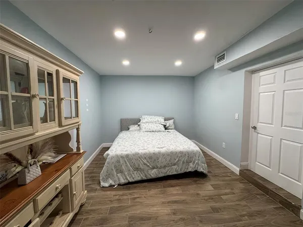 a bedroom with a bed and a dresser