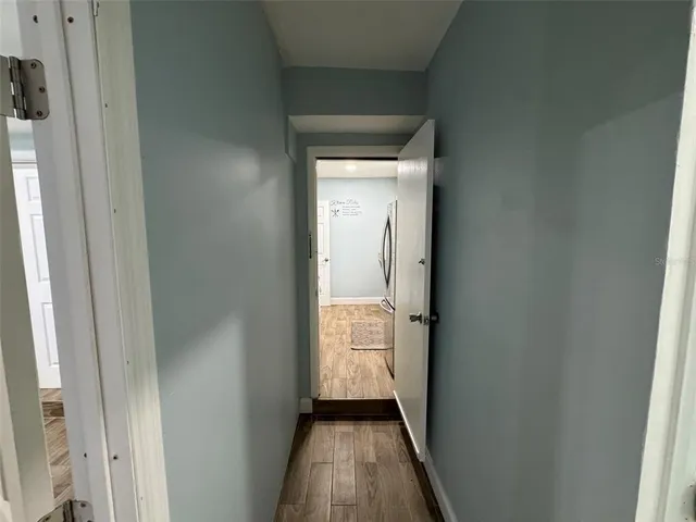 a view of a hallway with wooden floor