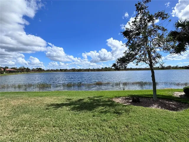 a view of a lake with houses in the back