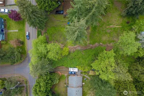 an aerial view of residential houses with outdoor space and swimming pool