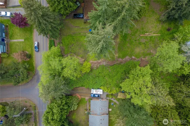 an aerial view of residential houses with outdoor space and swimming pool