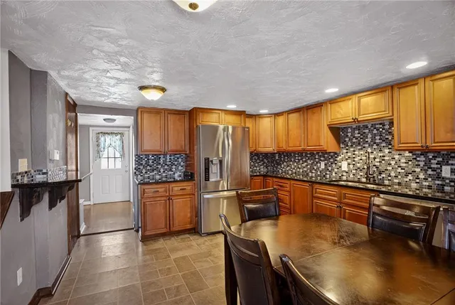 a kitchen with stainless steel appliances granite countertop a sink and cabinets