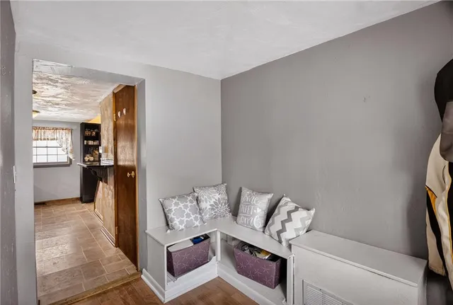 a living room with furniture and a kitchen