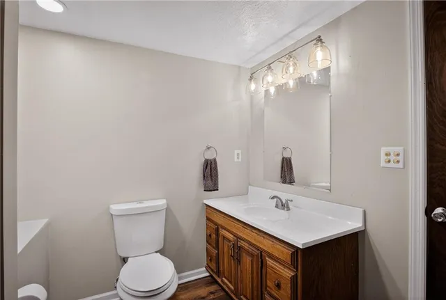 a bathroom with a sink a toilet and a mirror