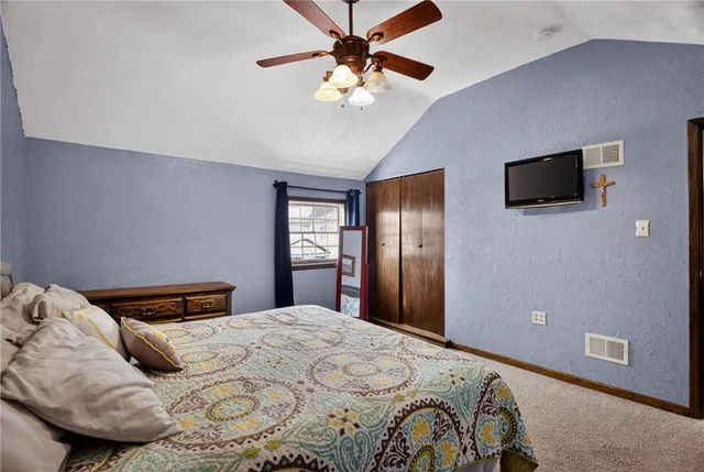 a bedroom with a bed and a tv