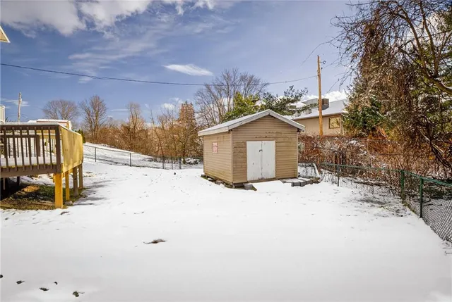 a view of a house with a snow in the yard