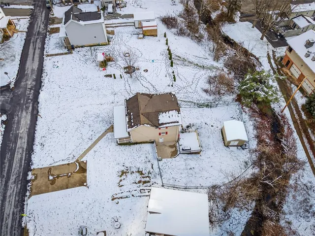 an aerial view of a house with outdoor space