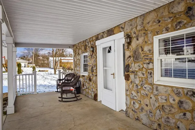 a view of a patio with table and chairs
