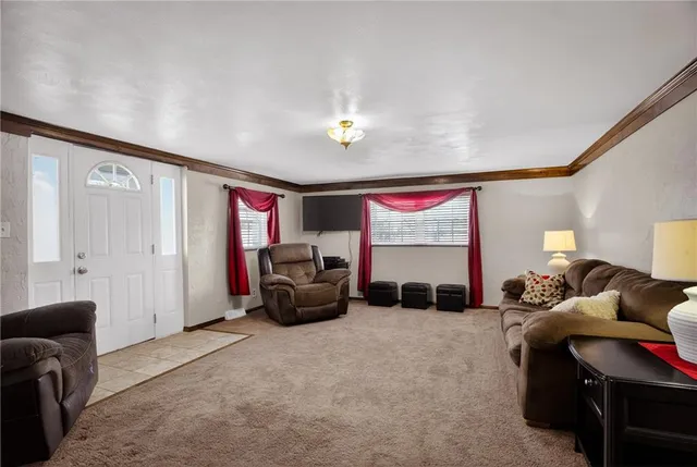 a living room with furniture gym equipment and a window