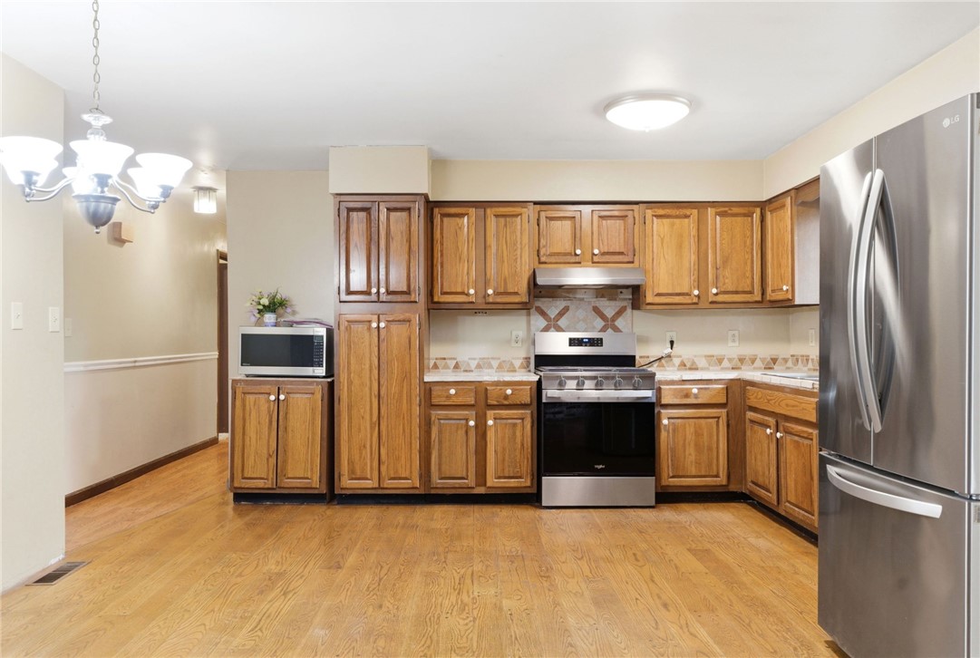 6711 Hamilton-Middletown Road Franklin, OH 45005 - Photo 14 of 49 This spacious kitchen offers a functional layout, hardwood flooring, and ample cabinetry for all your storage needs.
