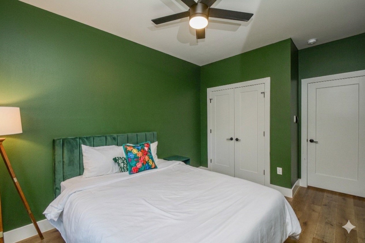 1504 Evelyn Street Houston, TX 77009 - Photo 14 of 15 a bedroom with a large bed and a chandelier