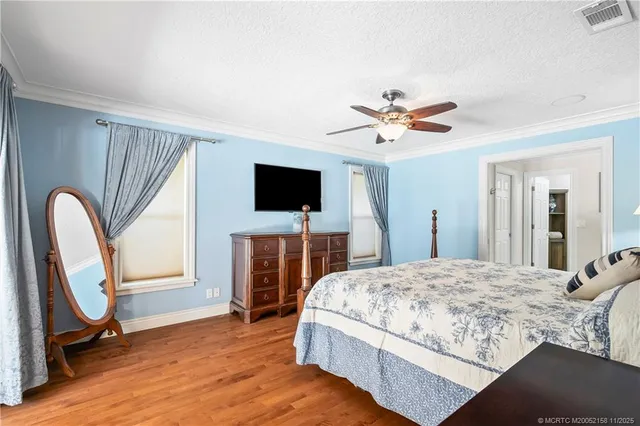 a bedroom with a bed and a glass door shower