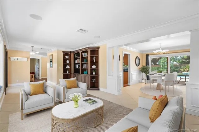 a living room with furniture and large windows