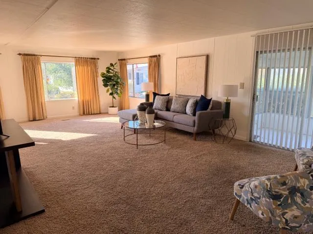 a view of a livingroom with furniture and a ceiling fan