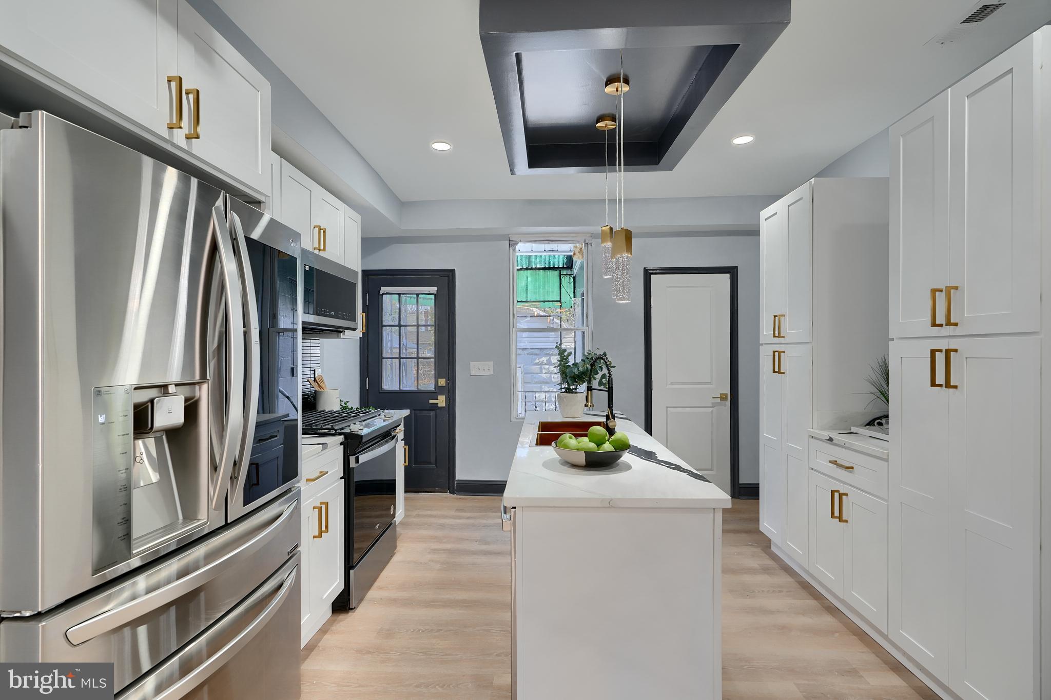 5012 Belair Road Baltimore, MD 21206 - Photo 22 of 61 an open kitchen with stainless steel appliances a refrigerator and a stove