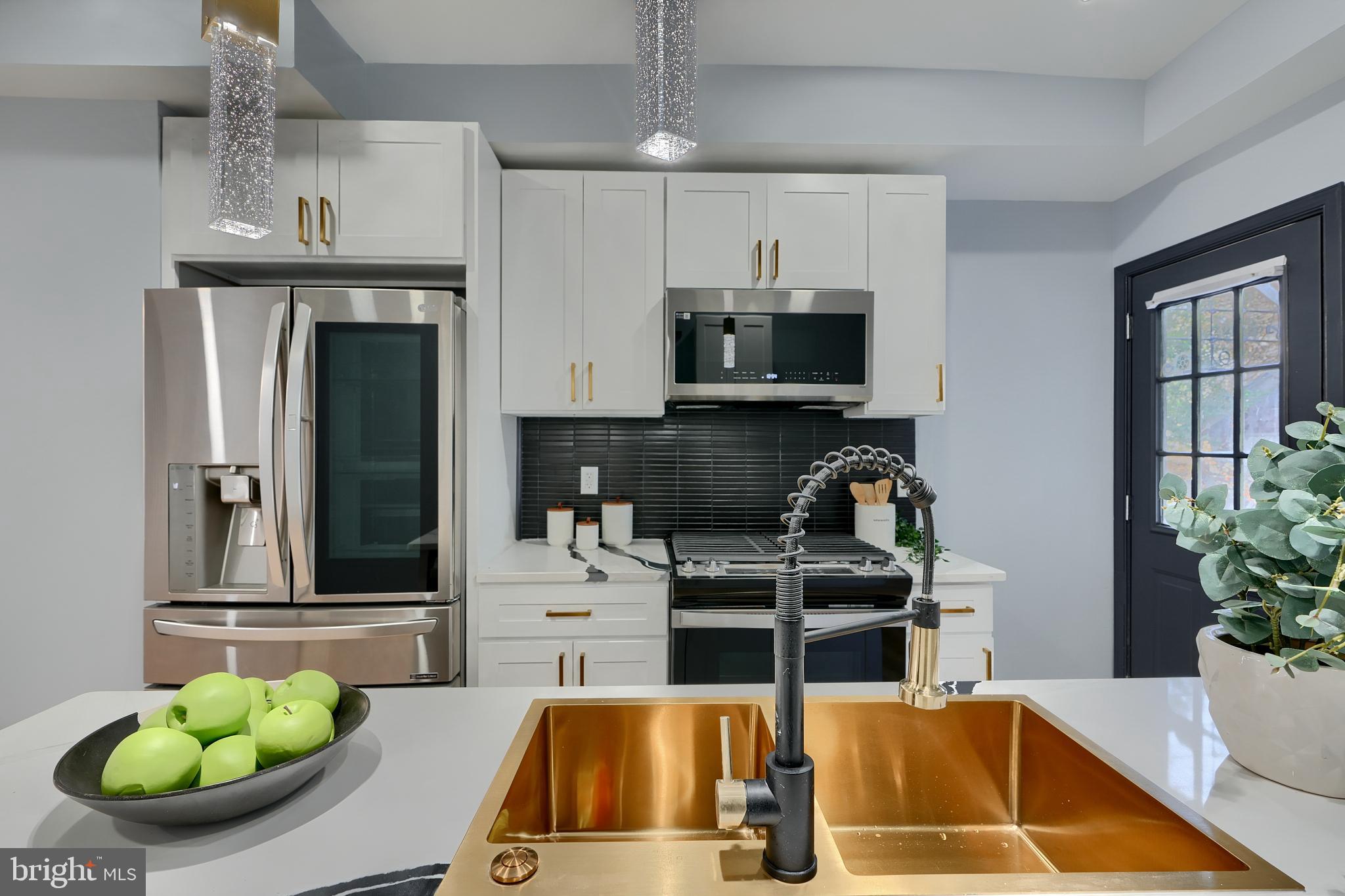 5012 Belair Road Baltimore, MD 21206 - Photo 25 of 61 a kitchen with stainless steel appliances a stove a sink and a white cabinets