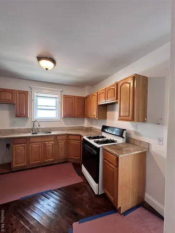 a kitchen with a stove sink and cabinets