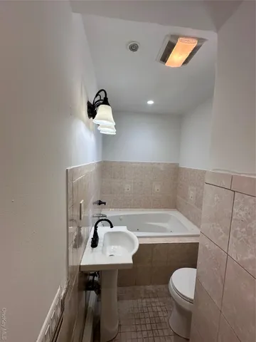 a bathroom with a sink toilet and mirror