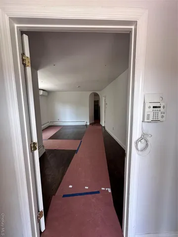 a view of empty room with wooden floor and window