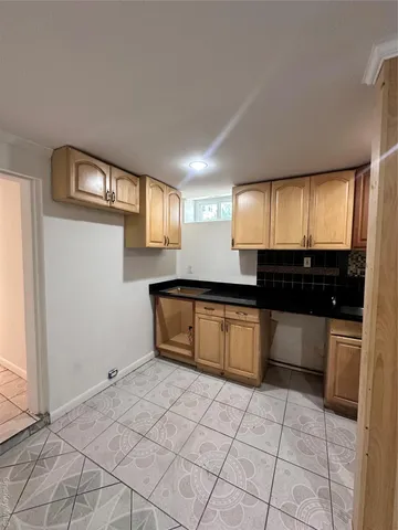 a room with a sink and cabinets