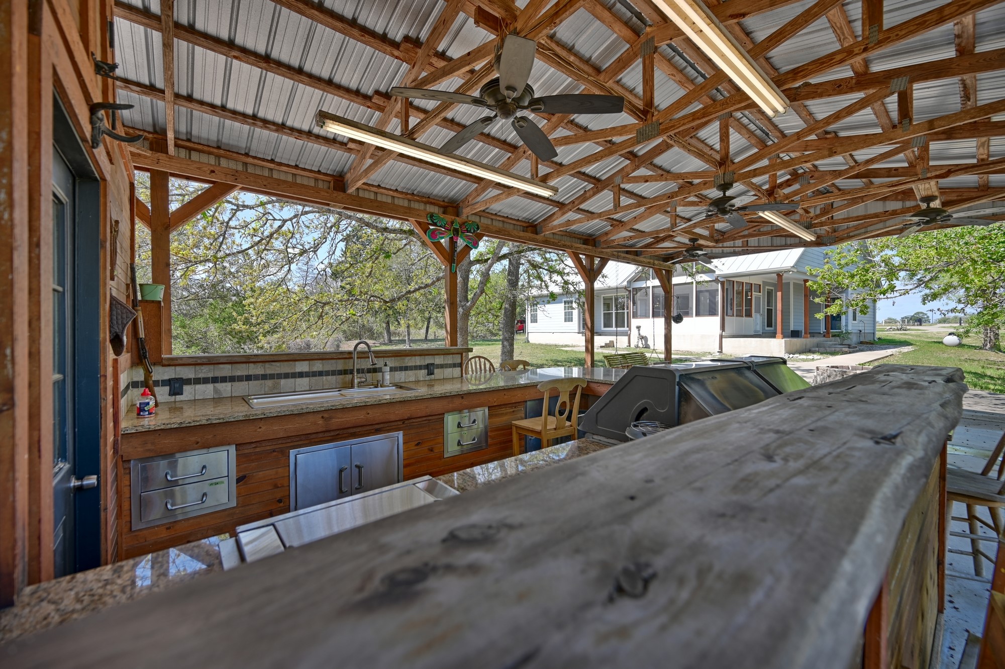 350 Owl Creek Road Giddings, TX 78942 - Photo 20 of 29 View of patio with ceiling fan and exterior kitchen