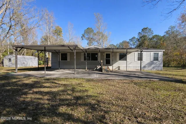 a view of a house with swimming pool and a yard