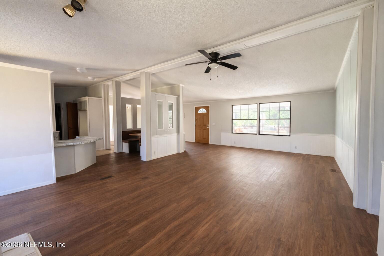 54052 Dornbush Road Callahan, FL 32011 - Photo 11 of 27 a view of an empty room with a window and wooden floor