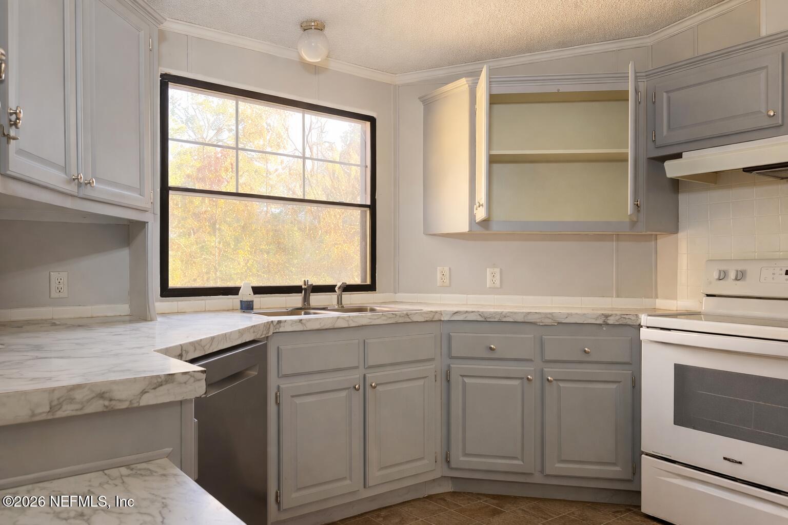 54052 Dornbush Road Callahan, FL 32011 - Photo 14 of 27 a kitchen with sink cabinets and window