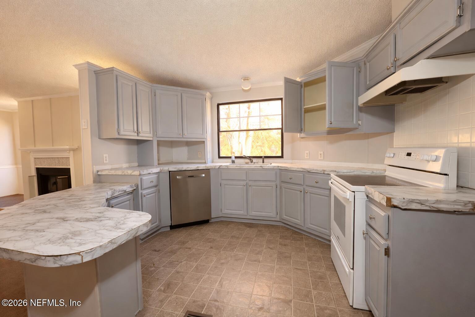 54052 Dornbush Road Callahan, FL 32011 - Photo 15 of 27 a kitchen with a sink stove and cabinets