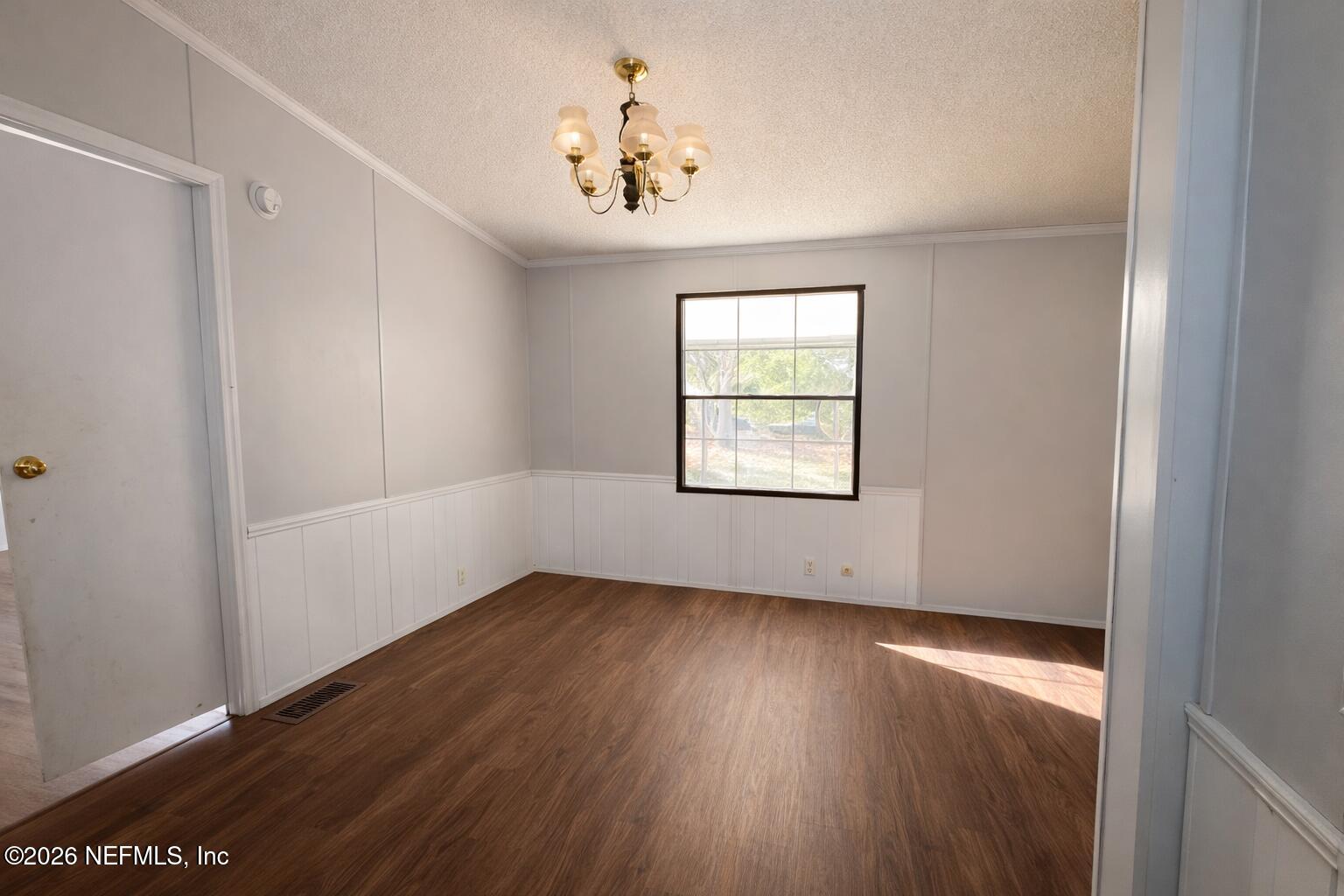 54052 Dornbush Road Callahan, FL 32011 - Photo 16 of 27 an empty room with wooden floor and windows