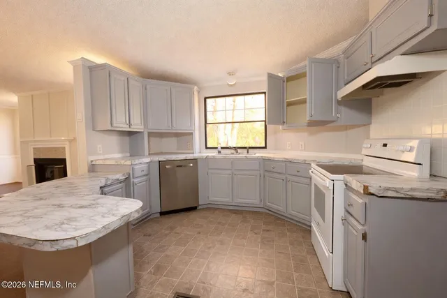 a kitchen with a sink stove and cabinets
