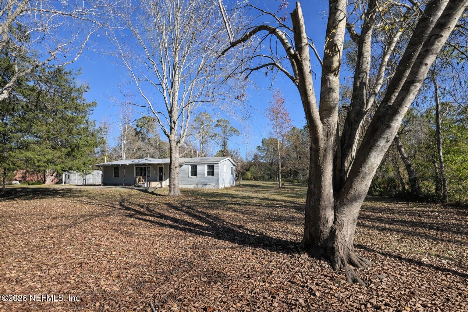 54052 Dornbush Road Callahan, FL 32011 - Photo 22 of 27 a view of a house with a yard