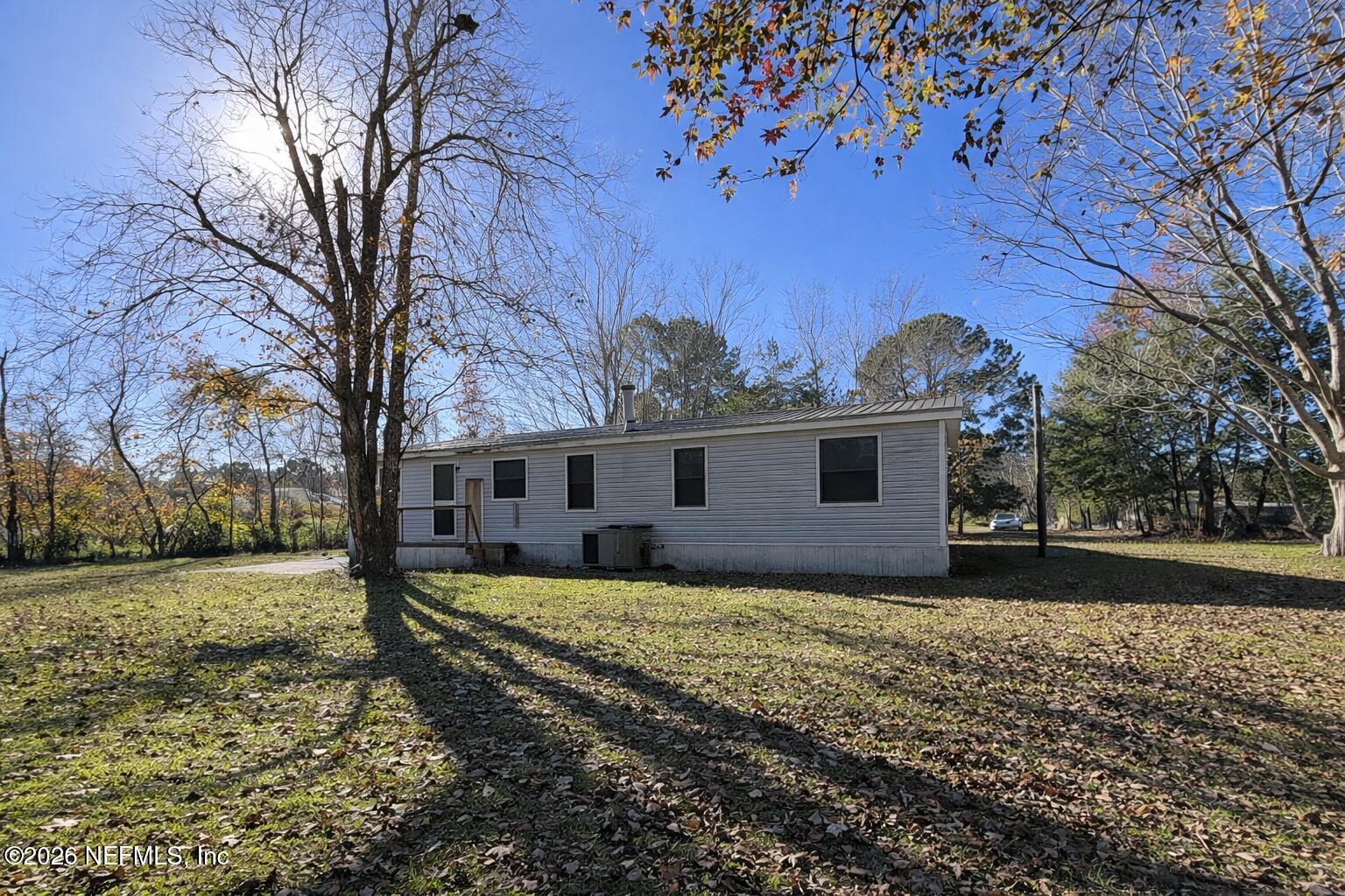 54052 Dornbush Road Callahan, FL 32011 - Photo 25 of 27 a house with trees in the background
