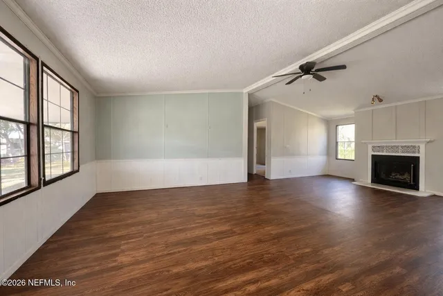 wooden floor in an empty room with a fireplace