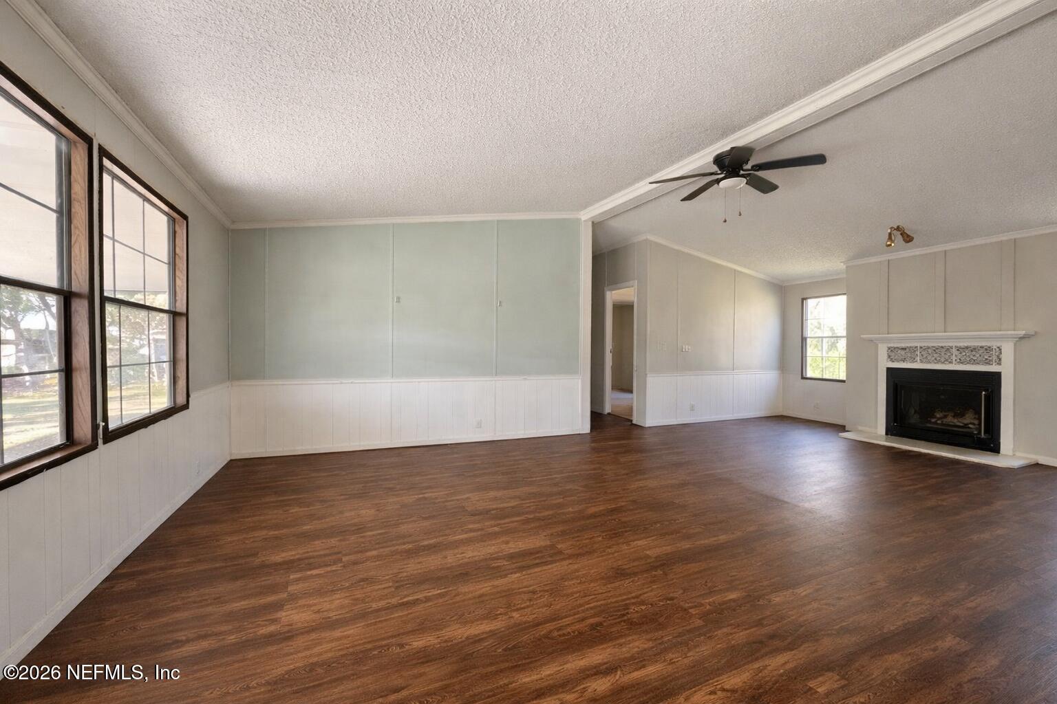 54052 Dornbush Road Callahan, FL 32011 - Photo 3 of 27 wooden floor in an empty room with a fireplace