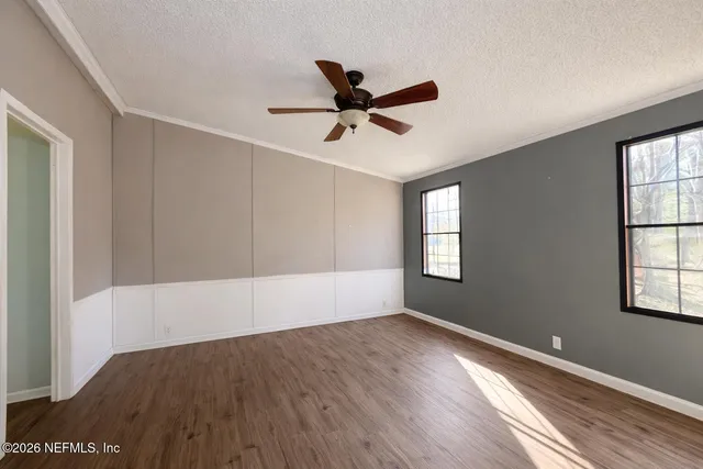 wooden floor in an empty room with a window