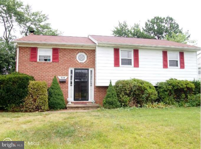 319 Holly Manor Road Baltimore, MD 21228 - Photo 1 of 17 a front view of a house with garden