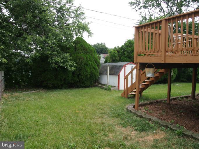 319 Holly Manor Road Baltimore, MD 21228 - Photo 14 of 17 a view of backyard with a barn and a large tree