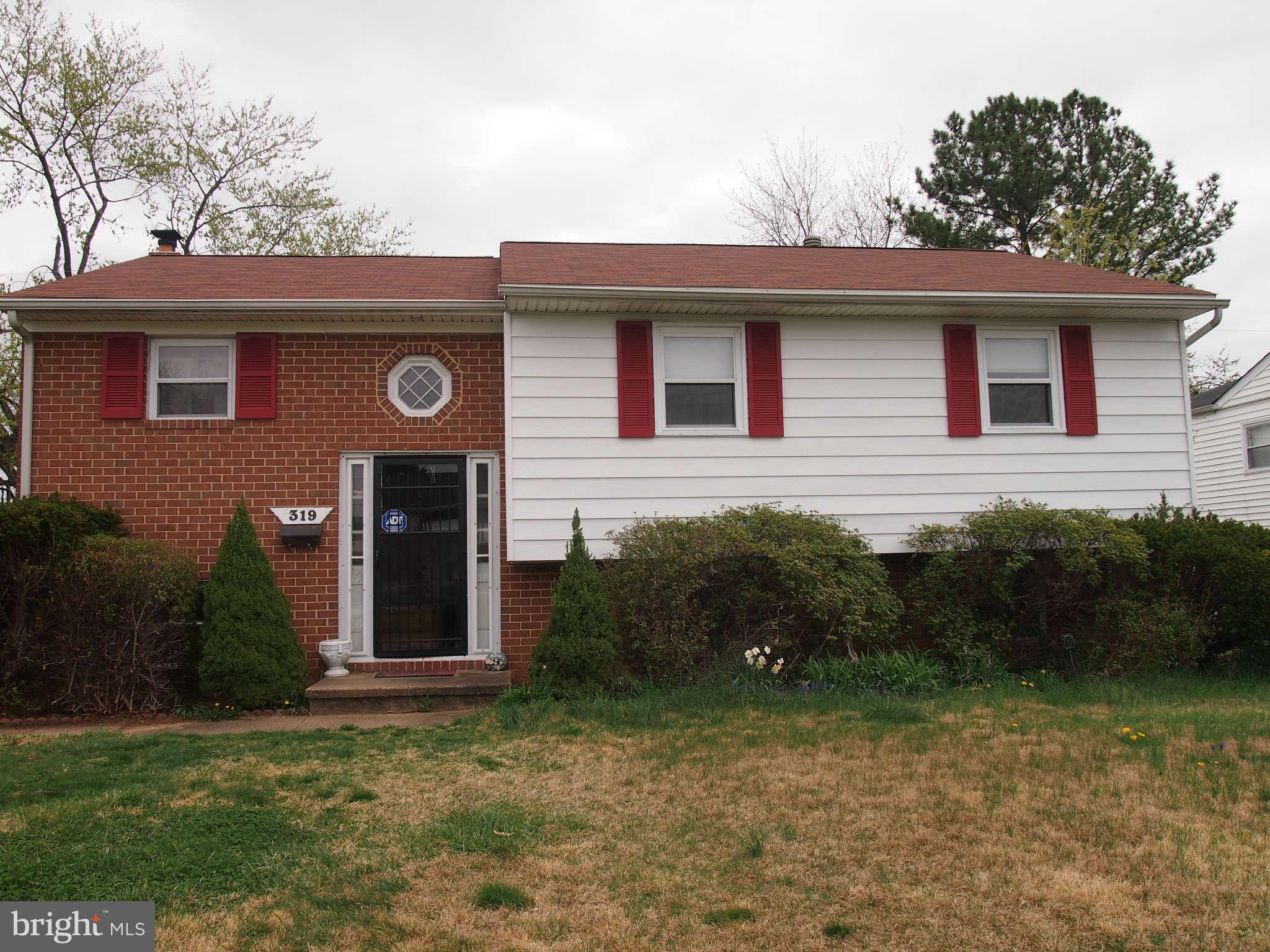 319 Holly Manor Road Baltimore, MD 21228 - Photo 16 of 17 a front view of a house with garden