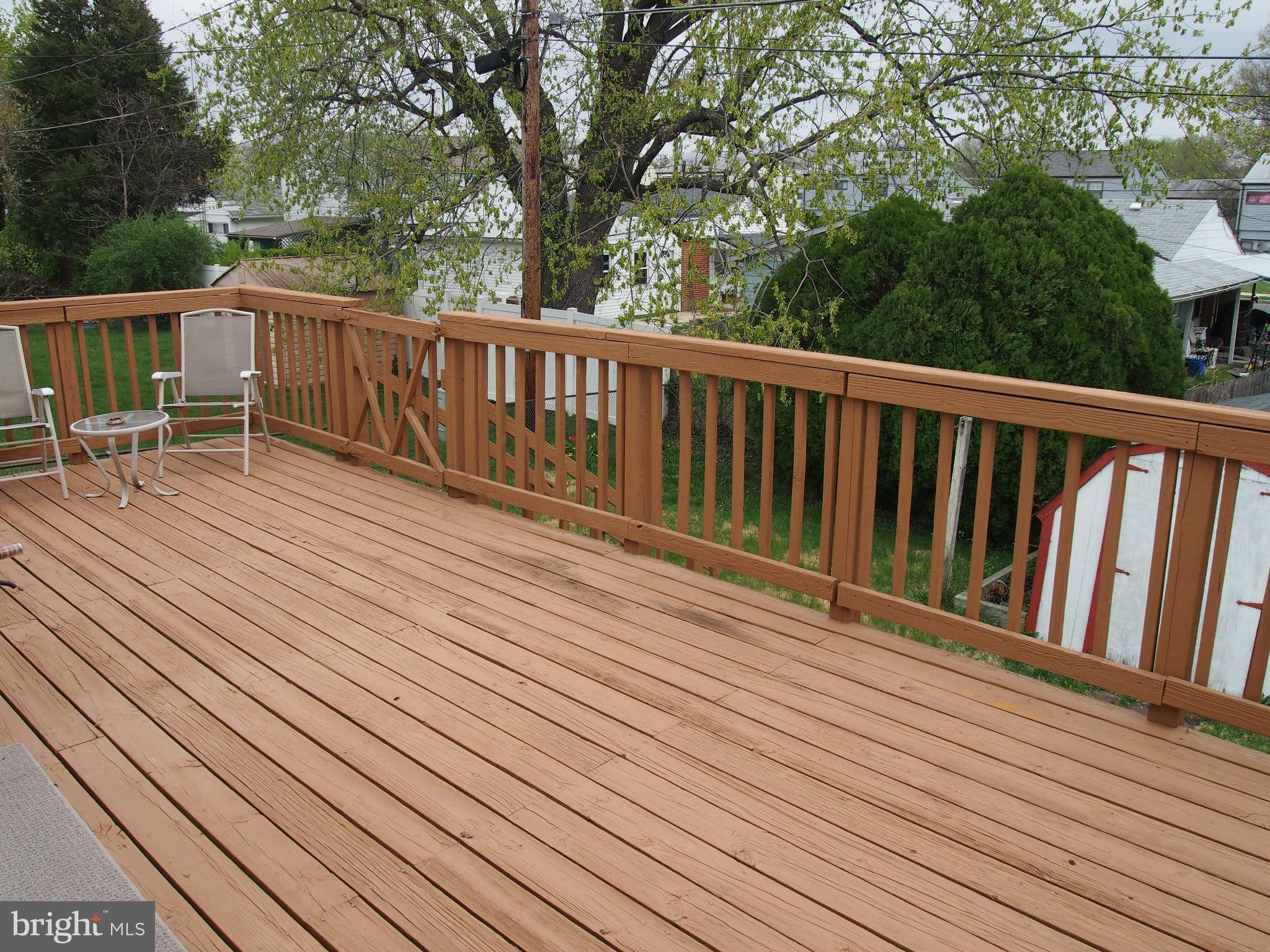 319 Holly Manor Road Baltimore, MD 21228 - Photo 5 of 17 a balcony with wooden floor and fence