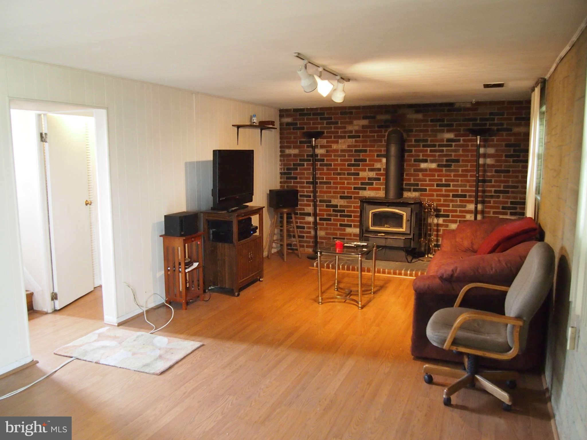 319 Holly Manor Road Baltimore, MD 21228 - Photo 7 of 17 a bedroom with furniture and a flat screen tv