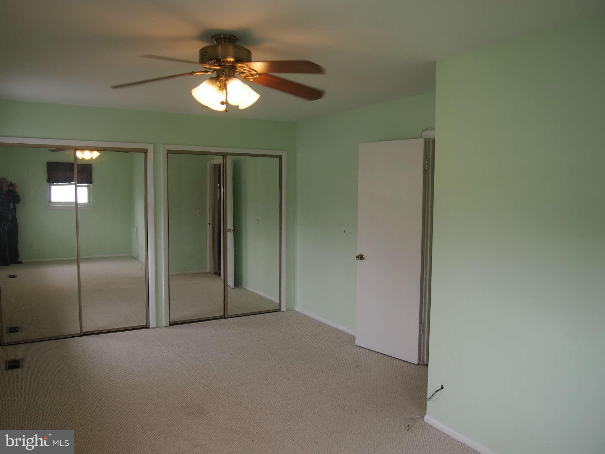 319 Holly Manor Road Baltimore, MD 21228 - Photo 9 of 17 a view of a livingroom with a chandelier fan