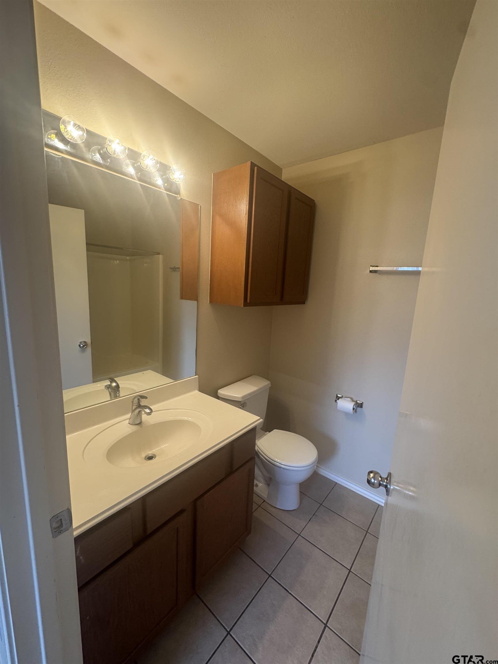 613 Hagan Road Whitehouse, TX 75791 - Photo 12 of 22 a bathroom with a sink and a mirror
